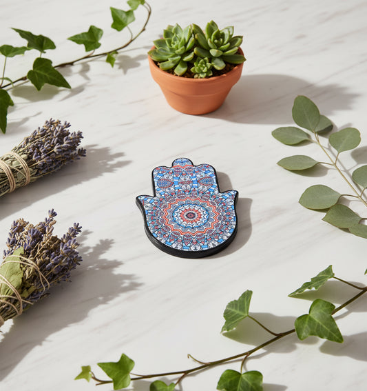 Decorative Hamsa hand with intricate patterns on a white background