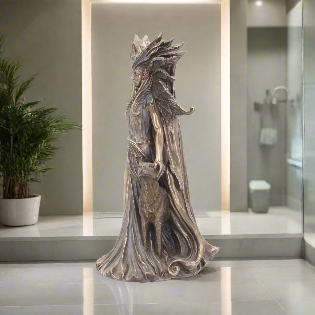 Statue of a hecate in ornate clothing with a white background