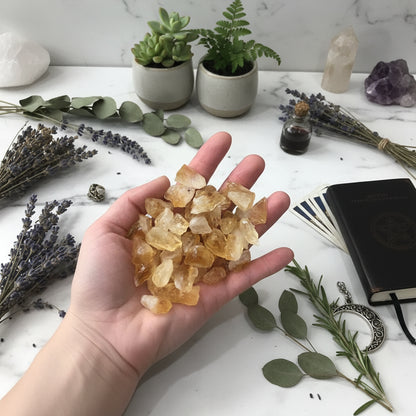 Hand holding a collection of yellow crystal rocks