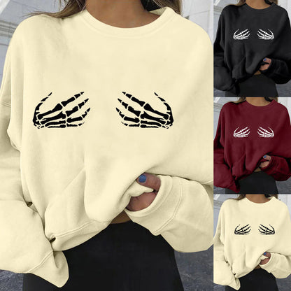 Beige sweatshirt with skeleton hand design worn by a person, shown in different colors.
