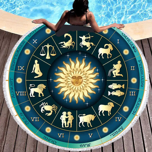 Round towel with zodiac design on a wooden deck by a pool