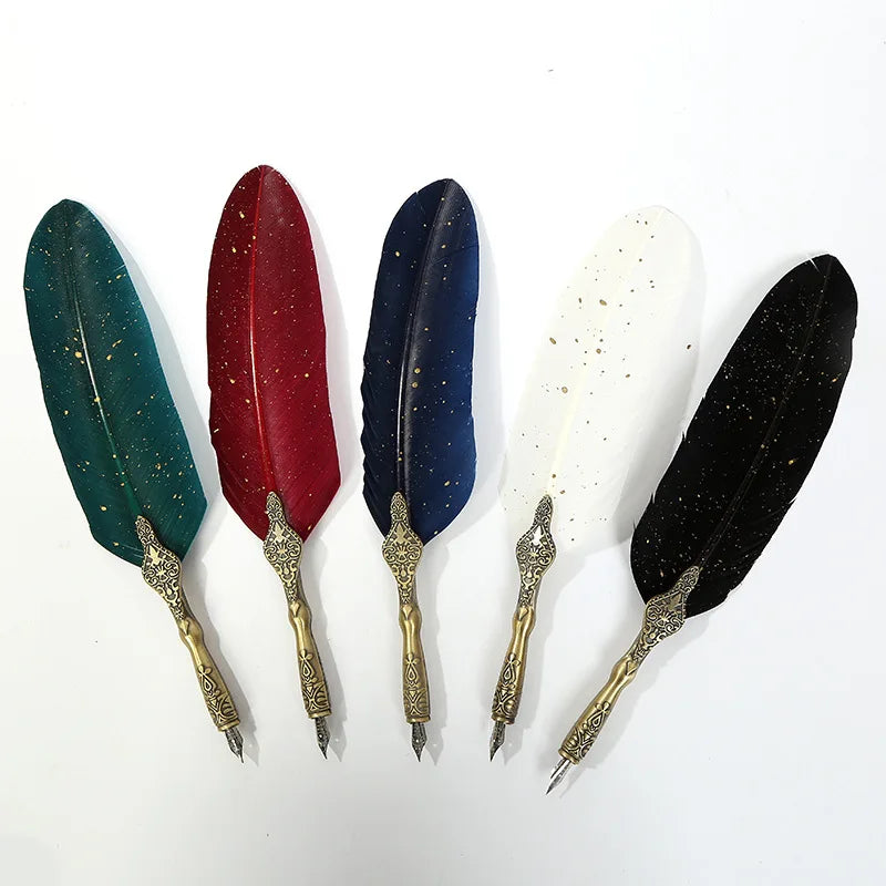 Set of six decorative feathers with ornate gold bases on a white background