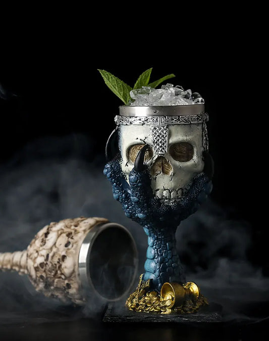 Skull-shaped cocktail glass with decorative elements on a dark background