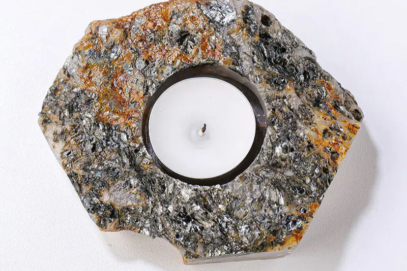 Decorative candle holder made of natural stone on a white background