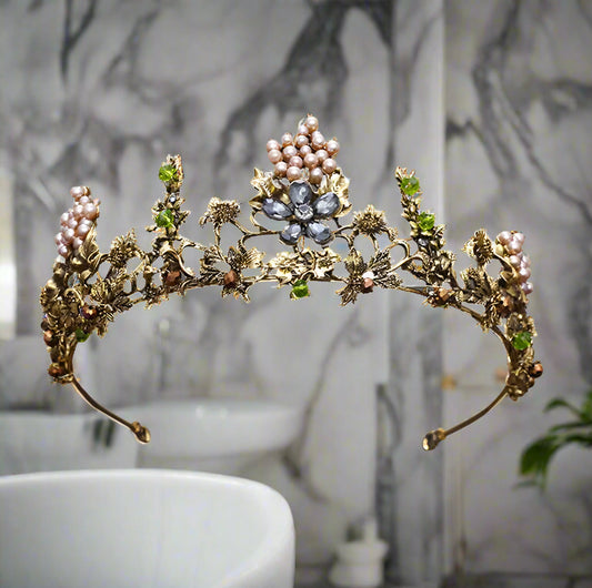 Decorative tiara with floral and berry-like embellishments on a white background