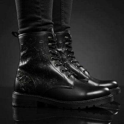 Gray boots with black and white tribal design worn by a person on a white background