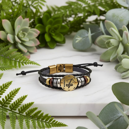 Bracelet with brown leather strap and gold and silver beads on a white background