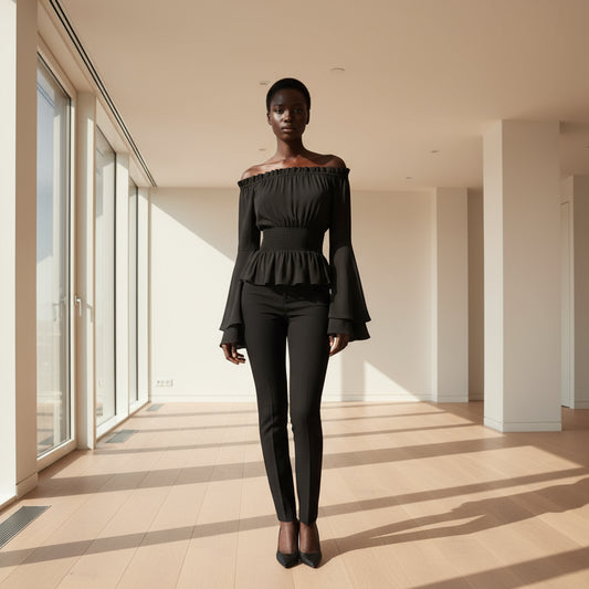 Black off-shoulder top with long sleeves on a white background