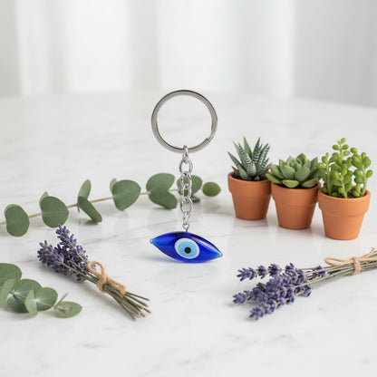 Keychain with a blue eye charm on a white background