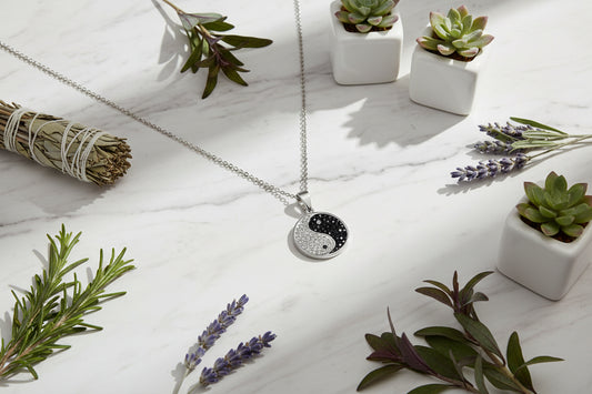 Silver yin yang pendant necklace on a black background