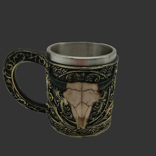 Decorative mug with skull design and intricate patterns on a white background