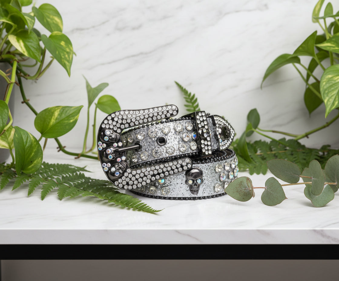 Decorative belt with rhinestone buckle and skull design on a white background