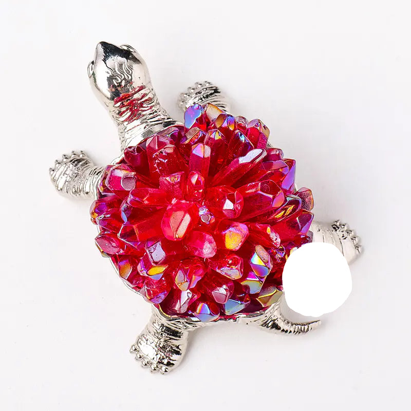 Tortoise-shaped object with a red, crystal-like shell on a white background