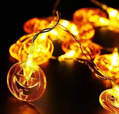 String lights with pumpkin design on a dark background