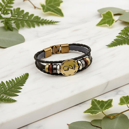 Bracelet with gold Gemini symbol charm on a white background