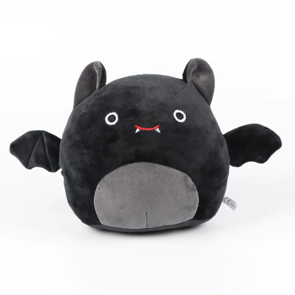 Black and gray plush toy with bat design on a white background
