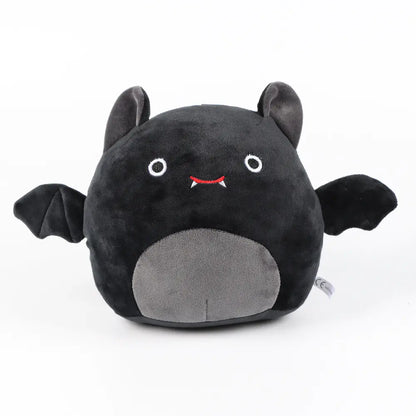 Black and gray plush toy with bat design on a white background