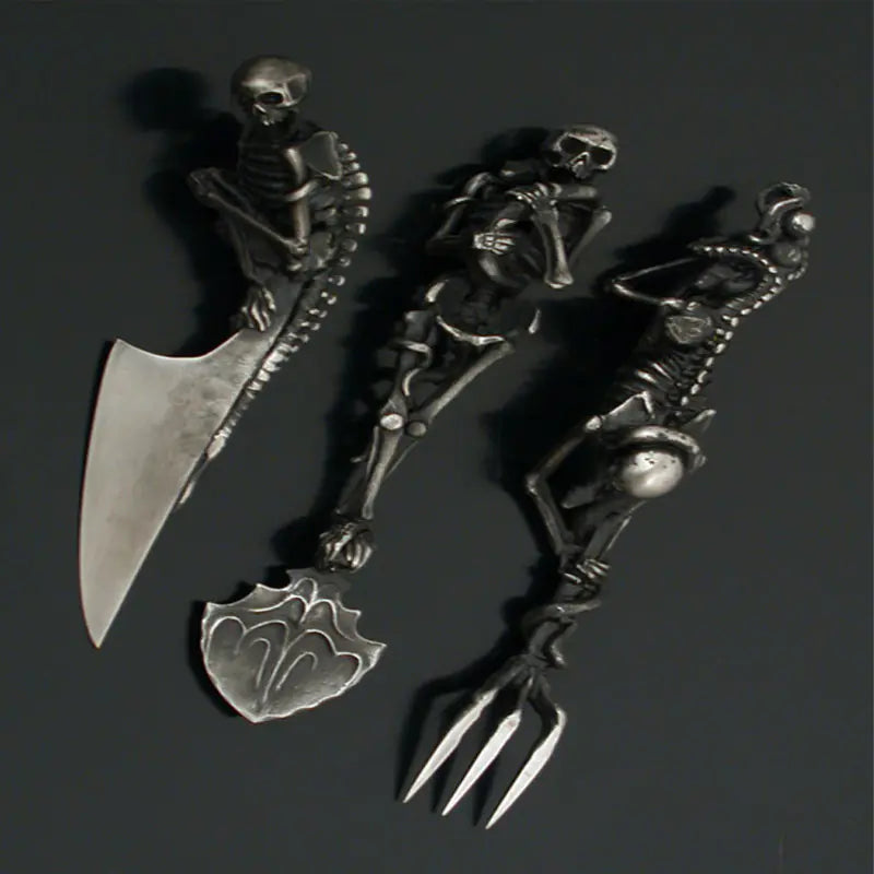 Decorative set of skeleton-themed cutlery on a dark background