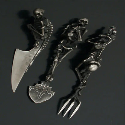 Decorative set of skeleton-themed cutlery on a dark background