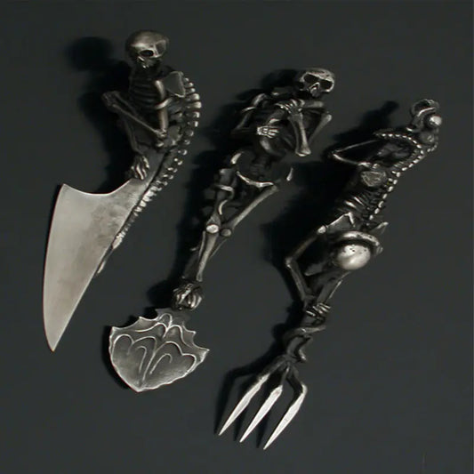 Decorative set of skeleton-themed cutlery on a dark background
