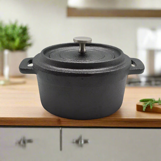 Black cast iron pot with lid on a white background
