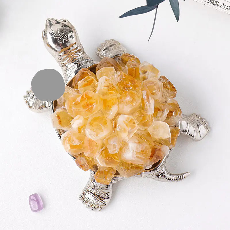 Decorative turtle figurine with crystal-like shell on a white background