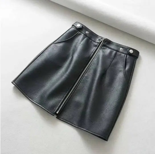 Black leather skirt on a light gray background