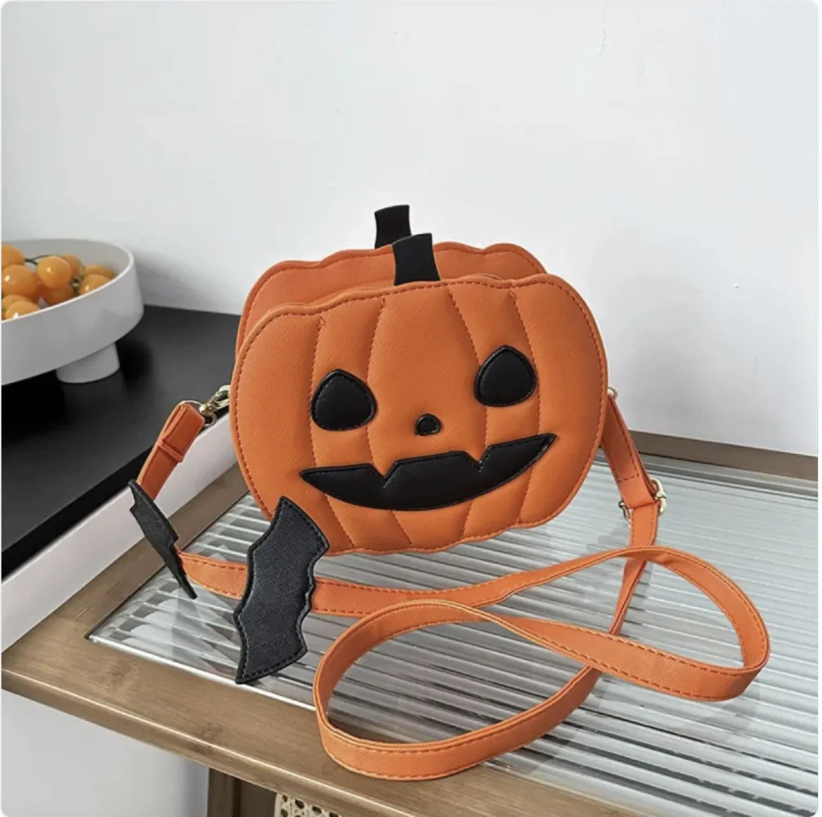 Pumpkin-shaped bag with a face on a table