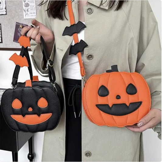 Two Halloween-themed bags, one black and orange, the other orange with a face, held by a person.