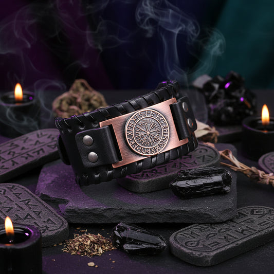 Black leather bracelet with a bronze Vegvisir pendant on a wooden surface.