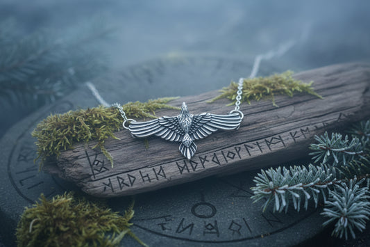 Silver eagle pendant necklace on a dark textured surface