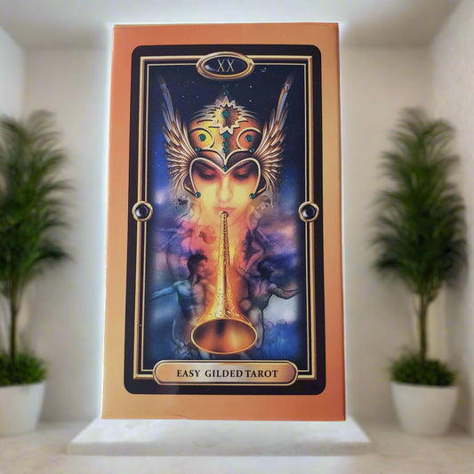 Tarot card packaging with intricate design and 'Easy Gilded Tarot' text on a light blue background