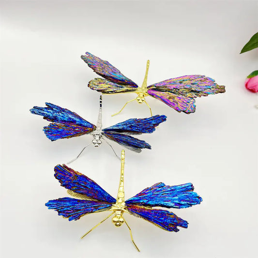 Three butterfly-shaped decorative items with iridescent wings on a white background