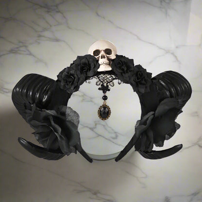 Gothic-style headband with black roses and skull design on a white background