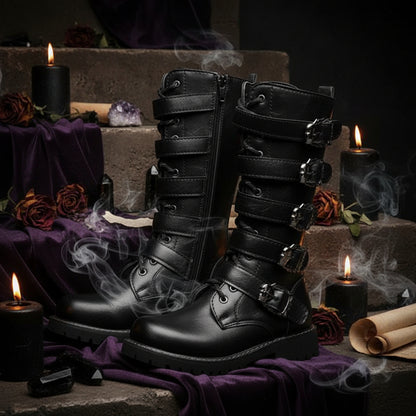 Black leather boots with multiple buckles on a white background