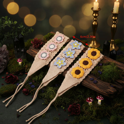 Three crocheted bookmarks with floral designs on a white background