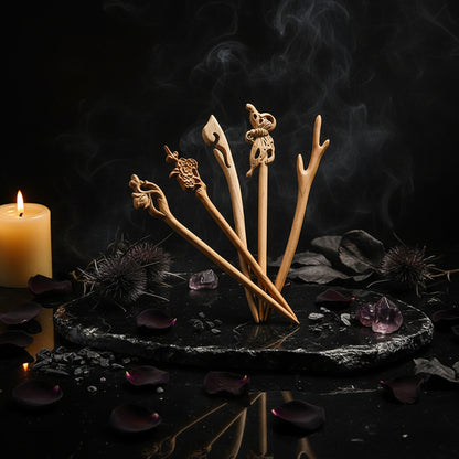Set of wooden hair sticks with intricate carvings on a white plate