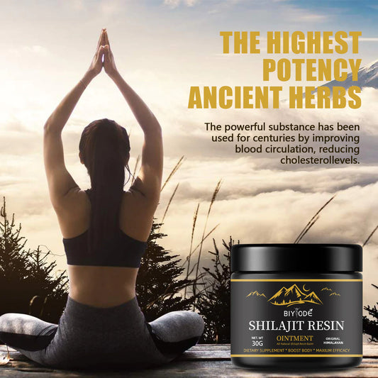 Person meditating with a container of Shilajit Resin Ointment in the foreground, set against a scenic background.