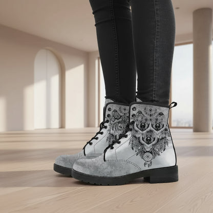 Gray boots with black and white tribal design worn by a person on a white background