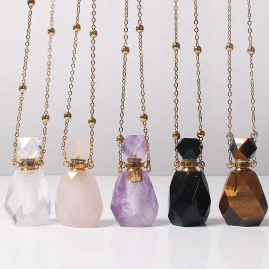 Five gemstone necklaces with chains on a white background