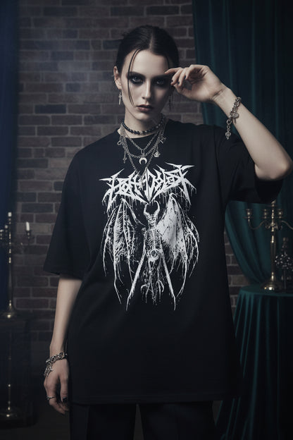 Person wearing a black t-shirt with a white graphic design, holding a phone.