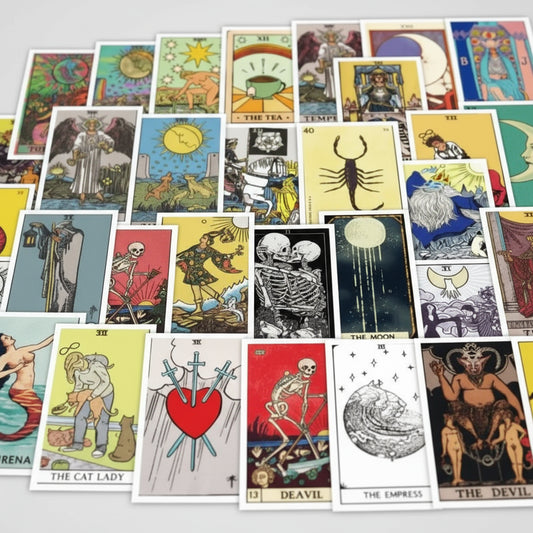 Collection of tarot cards with various designs and symbols on a white background.