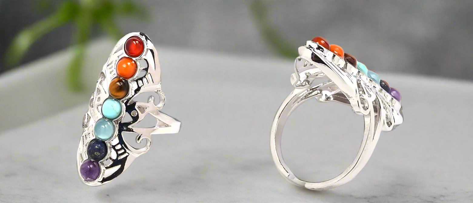 Silver ring with colorful gemstones on a white background