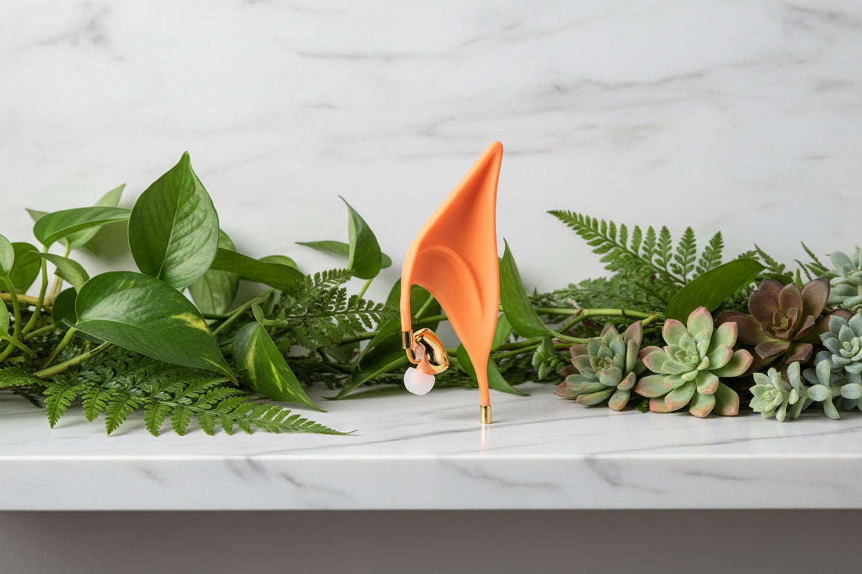 Orange elf ear with gold accents on a white background