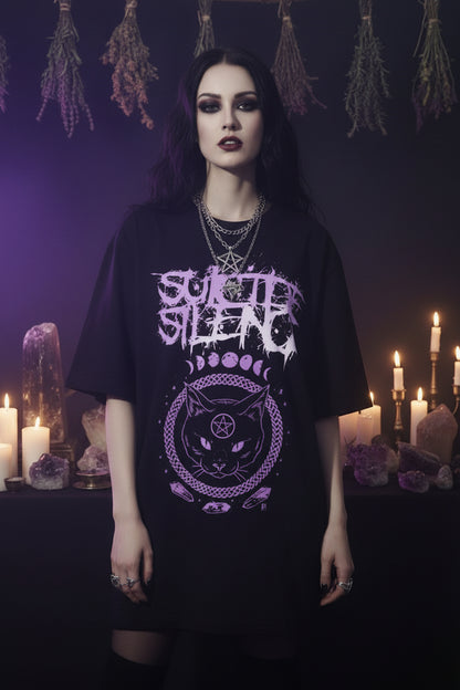 Person wearing a black 'Suicide Silence' t-shirt with purple graphics against a gray curtain background.