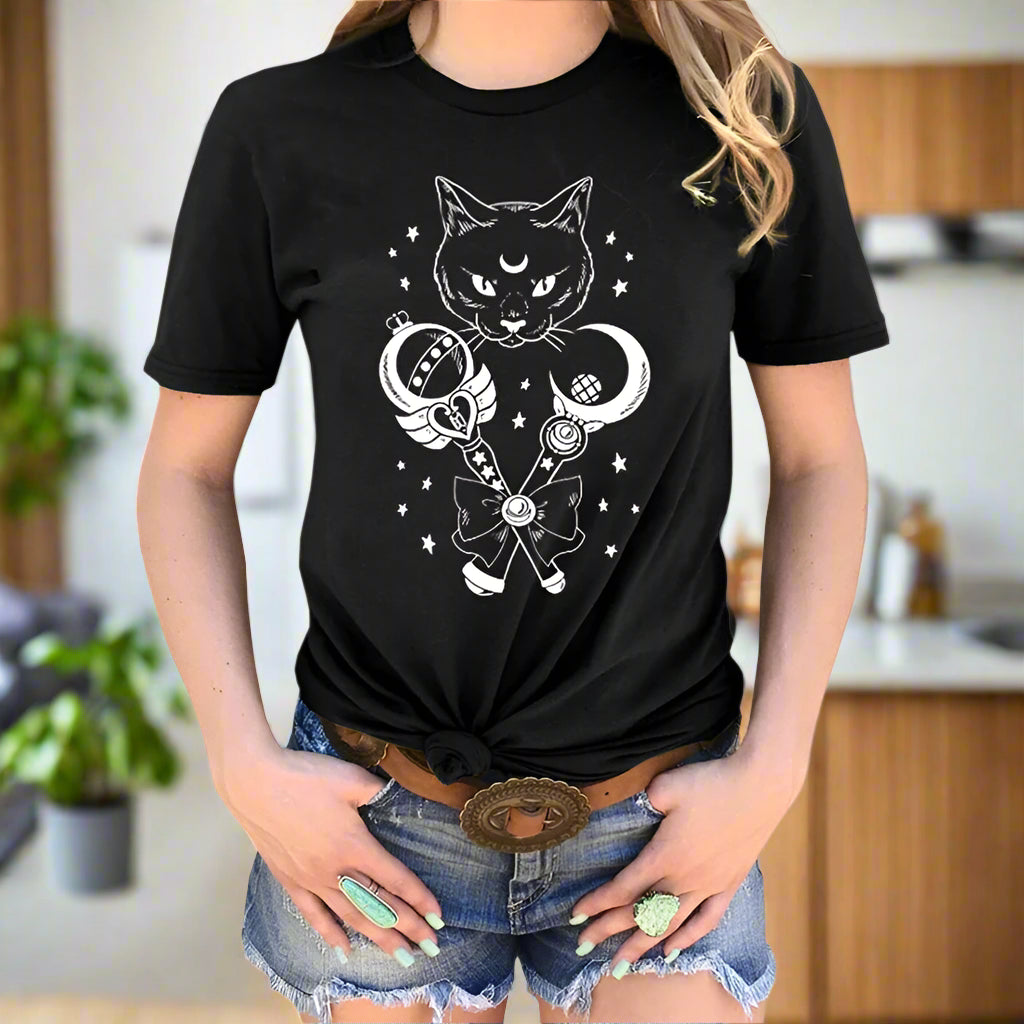 Black t-shirt with a cat and moon design worn by a person on a white background