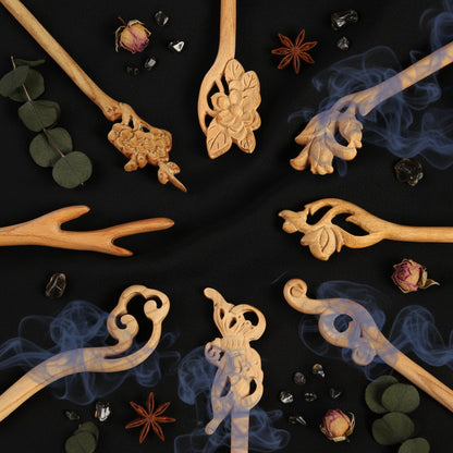 Decorative wooden sticks with intricate carvings on a black background