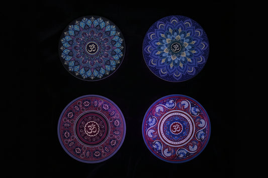 Four decorative plates with mandala designs on a white background
