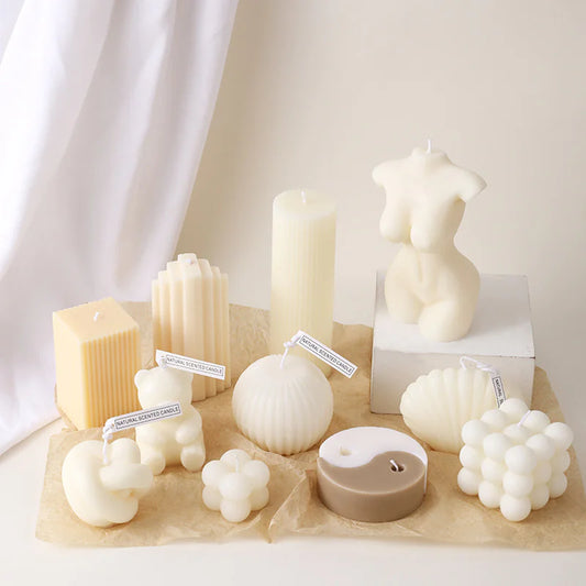 Collection of various candle shapes and sizes on a neutral background