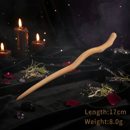 Wooden hair stick on a white stand with product details on a light background